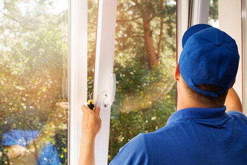 Man Replacing A Window — Merrillville, IN — Century Roofing Company Inc Man Replacing A Window — Merrillville, IN — Century Roofing Company Inc