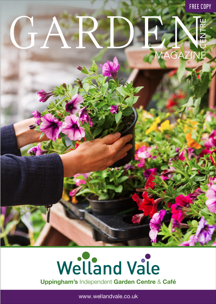Hands holding a pot of purple petunias in a garden centre, with the magazine title Garden and the Welland Vale logo.