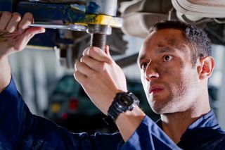 a mechainic is repairing a car