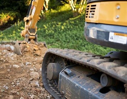 Close up of Excavator Treads — Septic system maintenance in White City, Oregon Close up of Excavator Treads — Septic system maintenance in White City, Oregon
