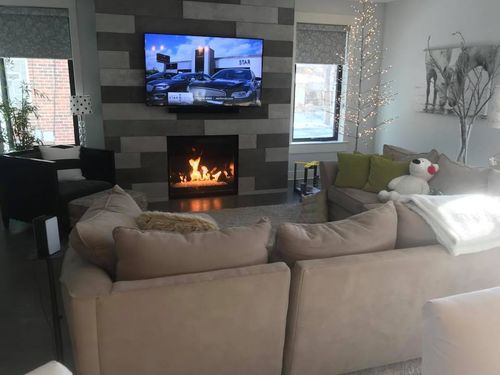 Natural stone fireplace fabricated and installed by L&E Marble and Granite
