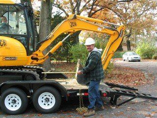 Backhoe Digging a Hole - Sewer Line Installations Backhoe Digging a Hole - Sewer Line Installations