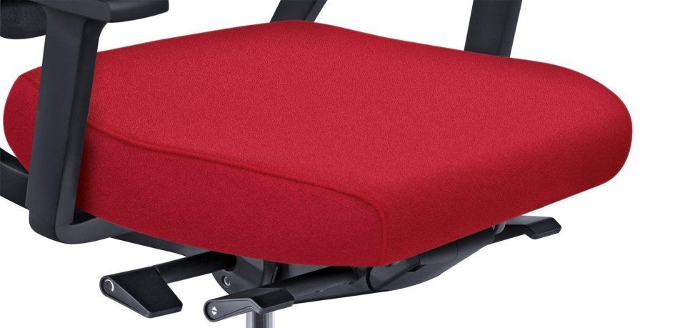 Un cuscino per sedia da ufficio di colore rosso acceso con braccioli neri e leve di regolazione sottostanti.