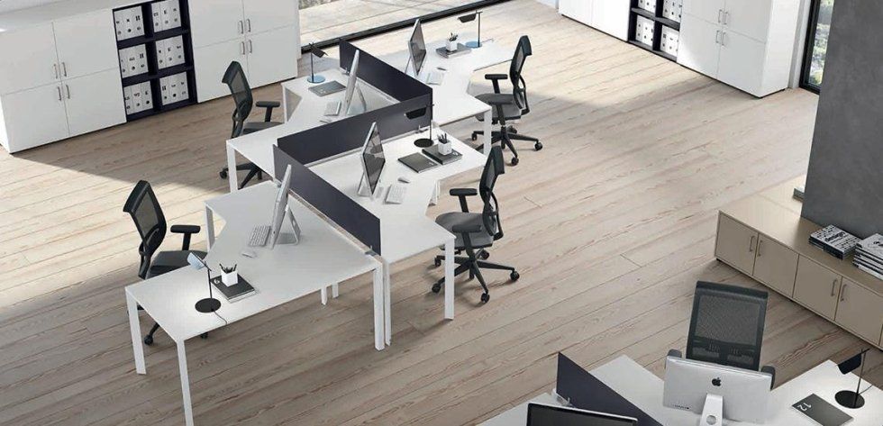 Vista dall'alto di un moderno spazio ufficio con scrivanie bianche a zig-zag e sedie ergonomiche su pavimento in legno.
