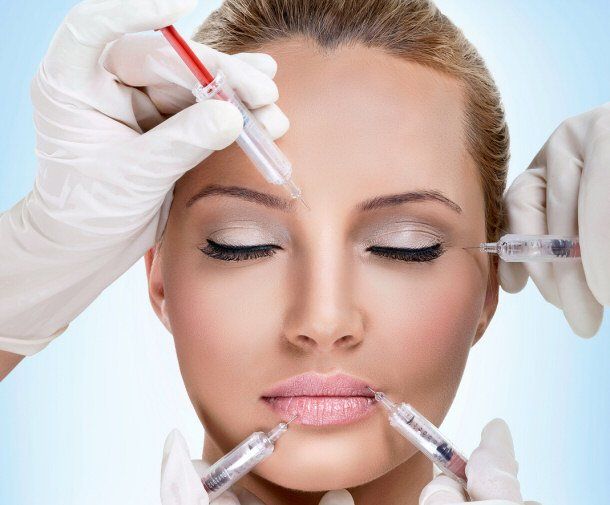 A woman is getting botox injections in her face.