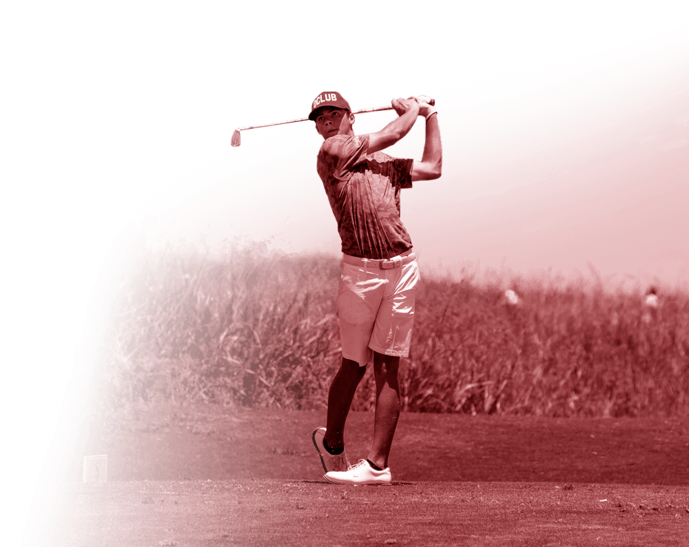 Golfer mid-swing on a tee box, holding a club against a red-tinted background