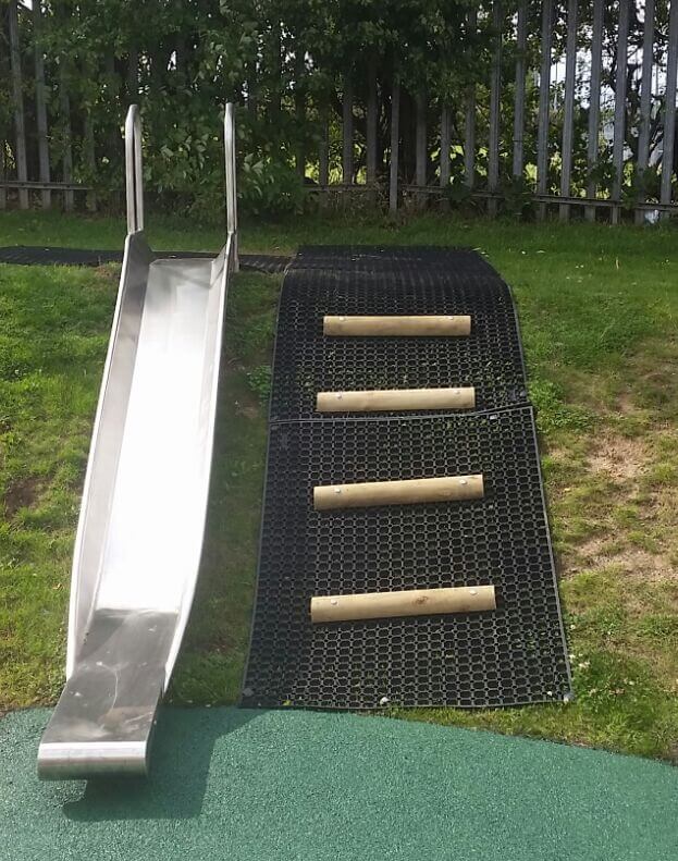 Playground Slide in Grass Banks with Steps