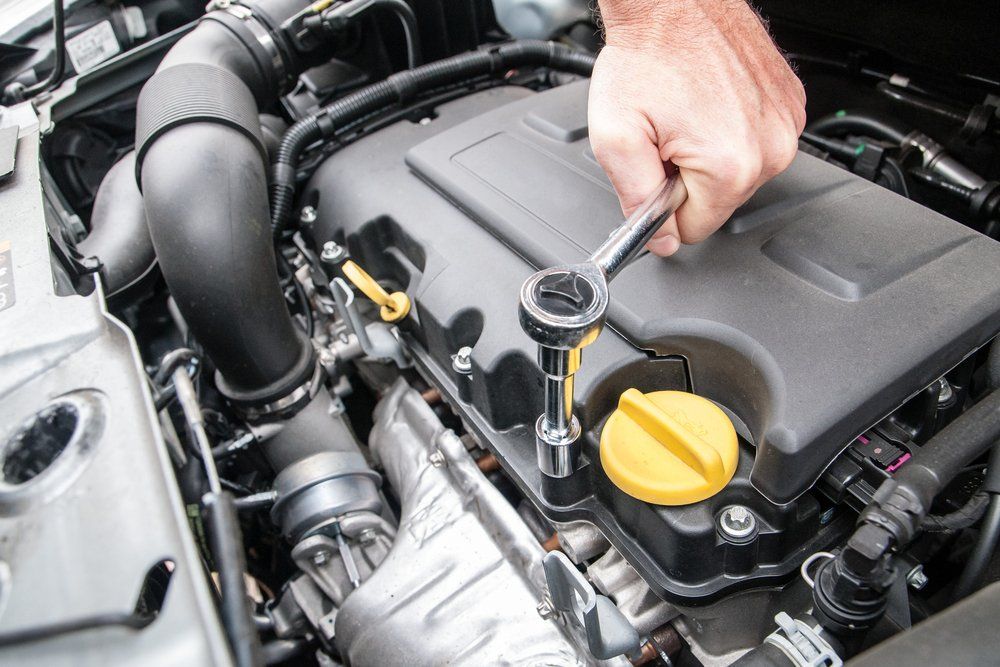 A Person is Working on a Car Engine With a Wrench — Mayne Street Auto in Gulgong, NSW