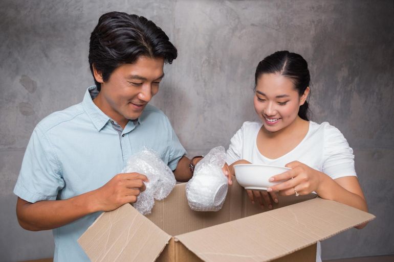 a couple unpacking kitchen ware