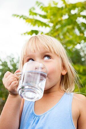 Child drinking water outdoors — Water Filtration in Orem, UT Child drinking water outdoors — Water Filtration in Orem, UT