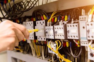 Technician With Multimeter Tester — Forrest, IL — RTJ Electric Technician With Multimeter Tester — Forrest, IL — RTJ Electric