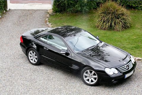A Mercedes Benz car parked on a driveway.