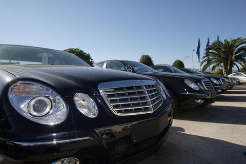 A row of Mercedes Benz's vehicles parked next to each other.