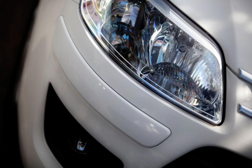Close up of a headlight on a white car