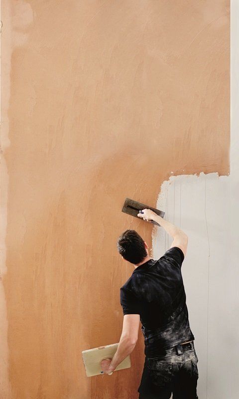 man plastering wall