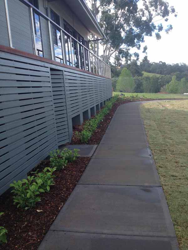 sidewalk next to building and grass