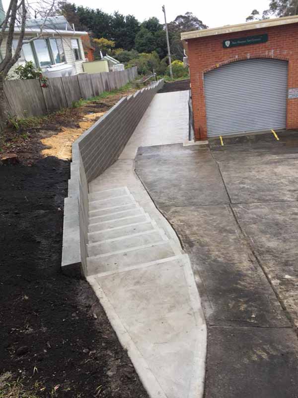 concrete stairs next to driveway