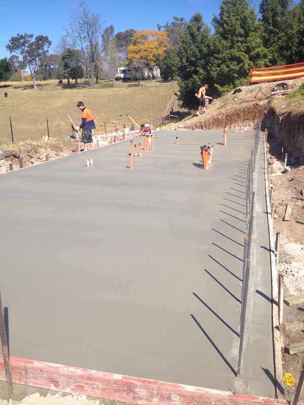 person working next to new concrete