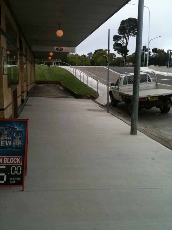 concrete sidewalk and storefronts