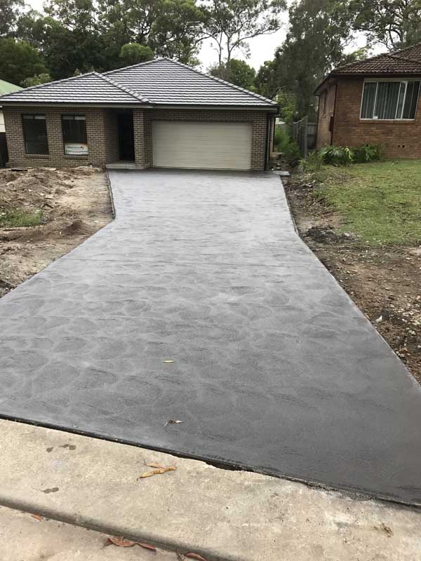 house with long wide concrete driveway