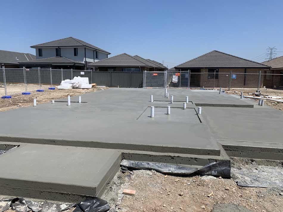car next to poured concrete foundation