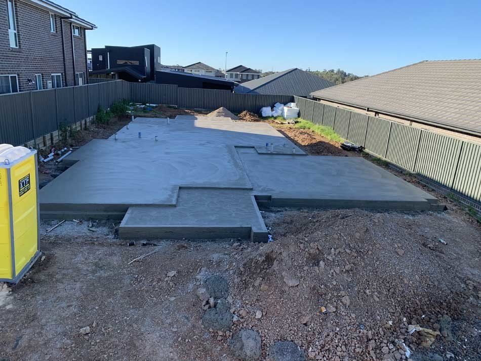 person working on concrete foundation