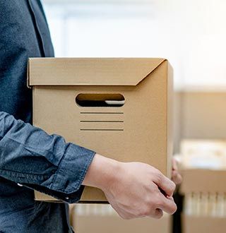 Worker Carrying Package — Herndon, VA — Eureka Van & Storage Co., Inc.