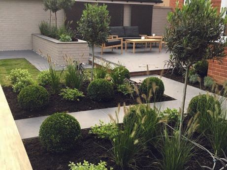 A garden with a couch and chairs in it