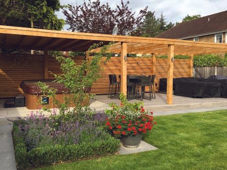 A backyard with a pergola and a hot tub