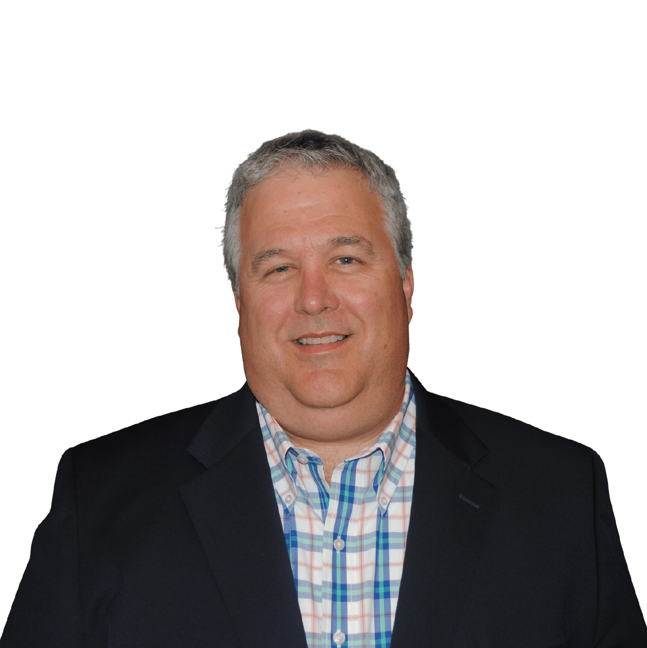 A man in a suit and plaid shirt is smiling for the camera.
