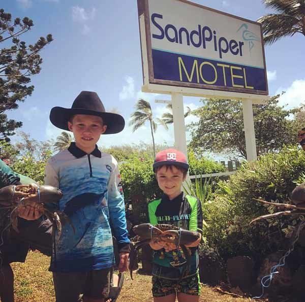 two kids holding fish