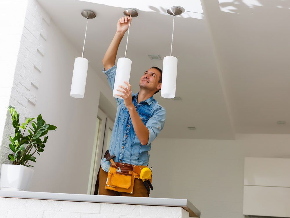 Electrician Fixing Light On Ceiling — Lebanon, PA — Mid Penn Electrical Services Electrician Fixing Light On Ceiling — Lebanon, PA — Mid Penn Electrical Services