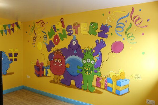 mini monsterz soft paly logo mural with additional monsters in the party room