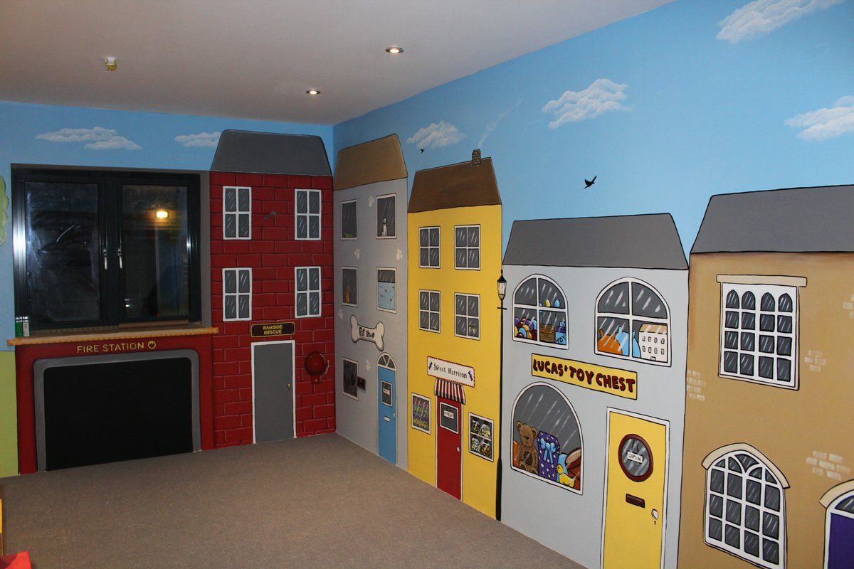 Kids playroom mural with shops and a fire station 
