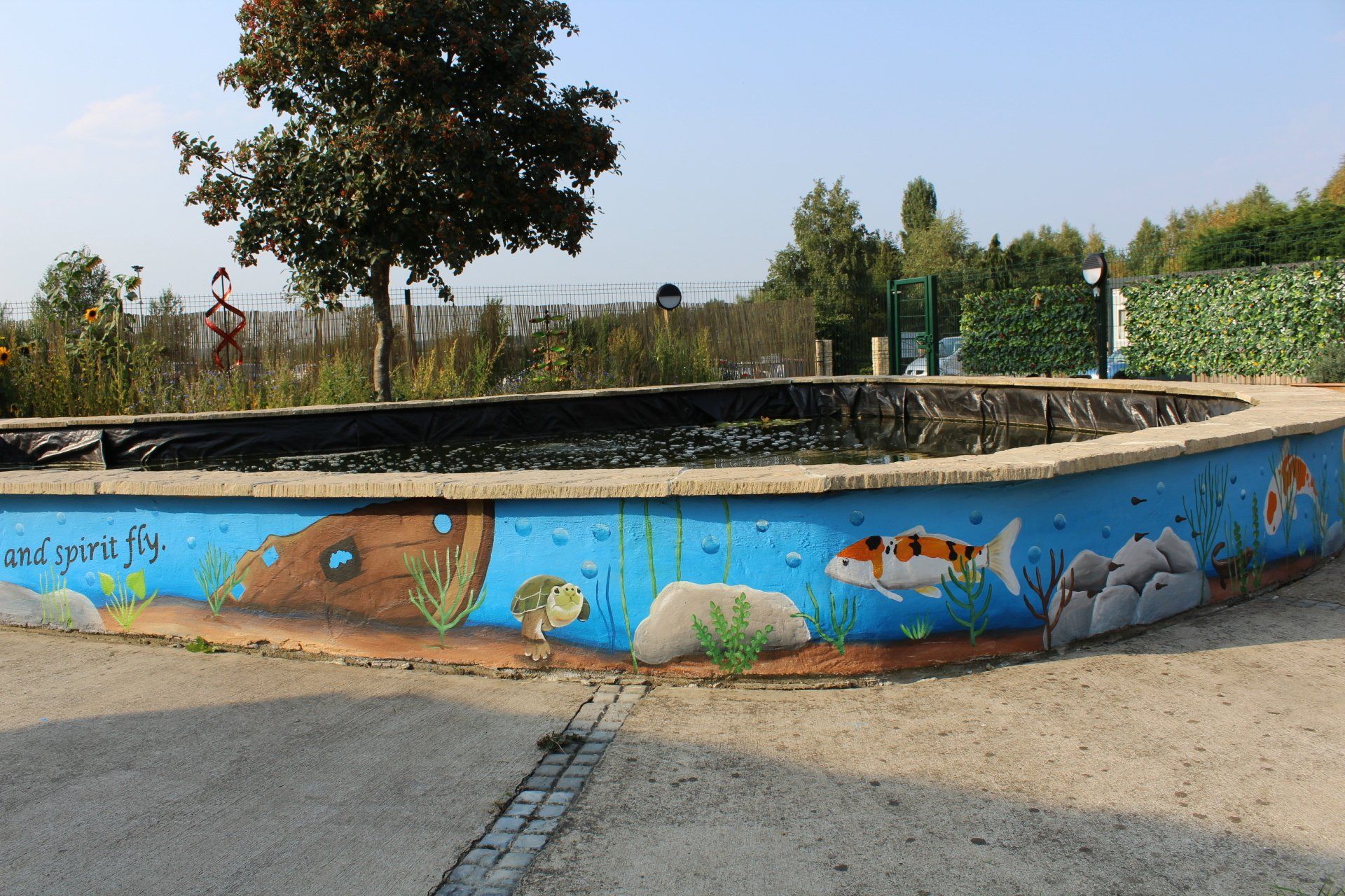 Daisy chain pond mural with an under the sea mural running around it