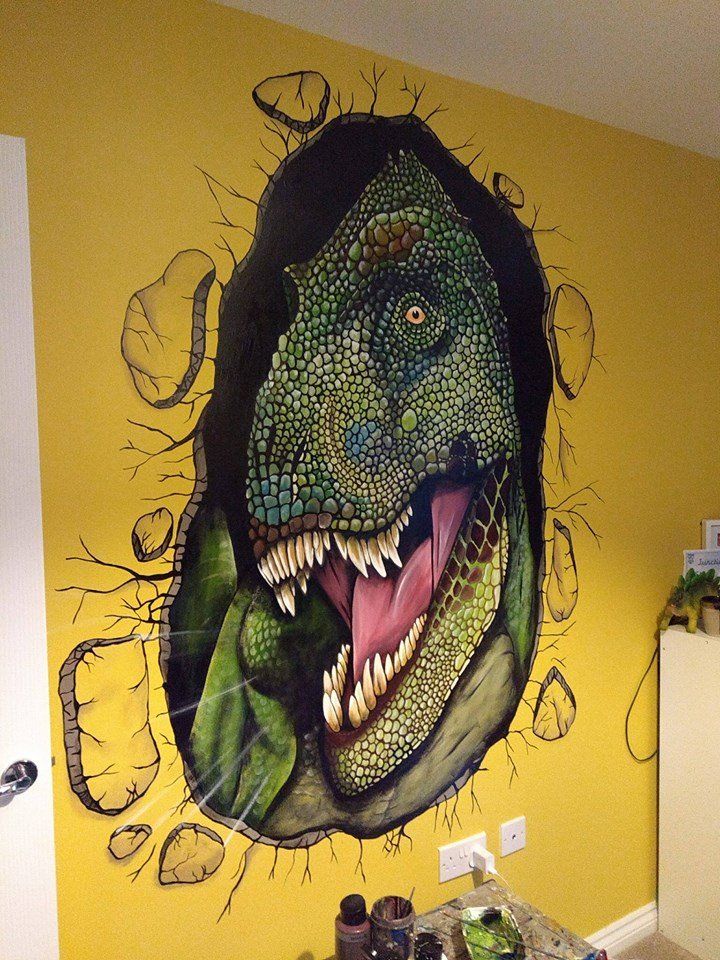 dinosaur bursting through the wall mural in a kids room 