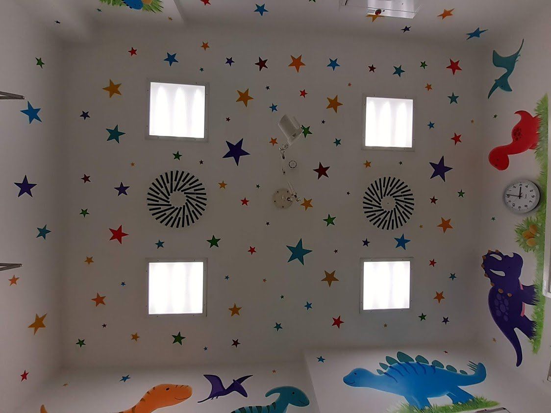 dinosaur mural stars on the ceiling for the children to count as they fall asleep in the theatre at james cook NHS hospital