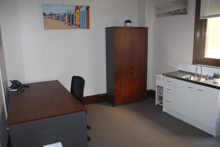 Consult room with casual seating area & sink