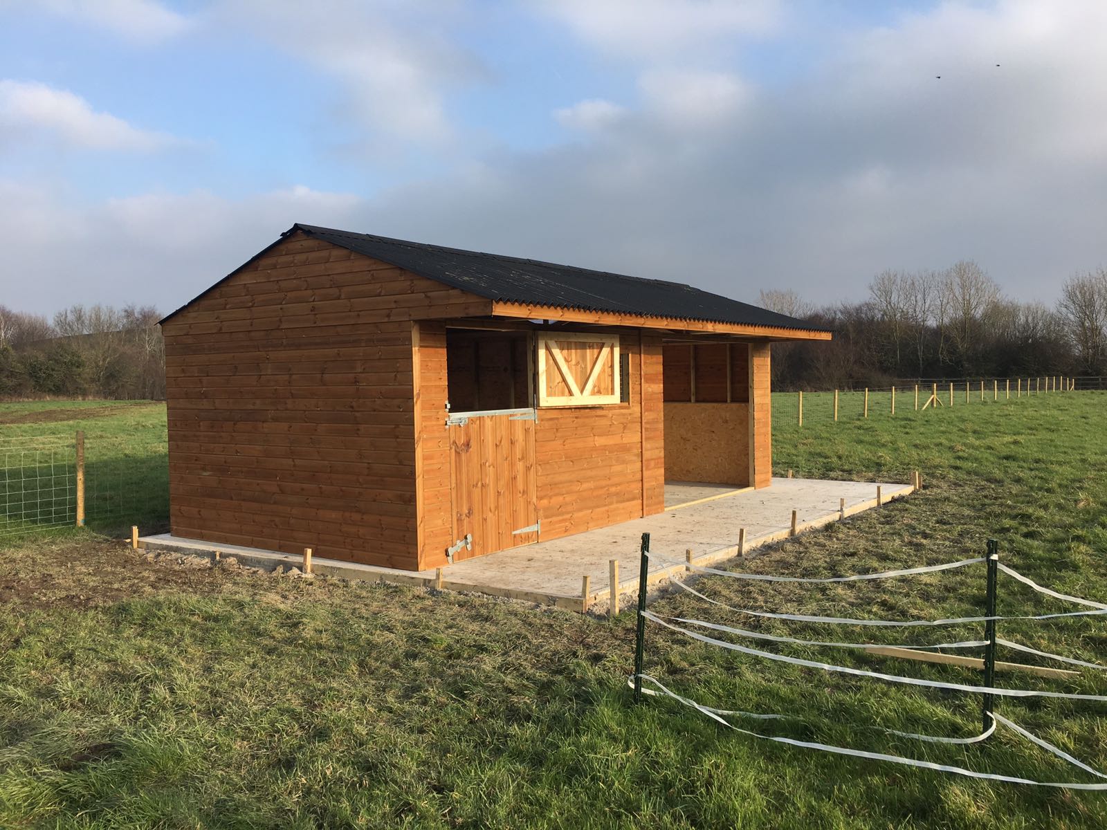 stable and field shelter in a field