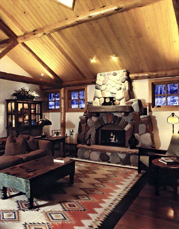 A living room with a fireplace and a rug
