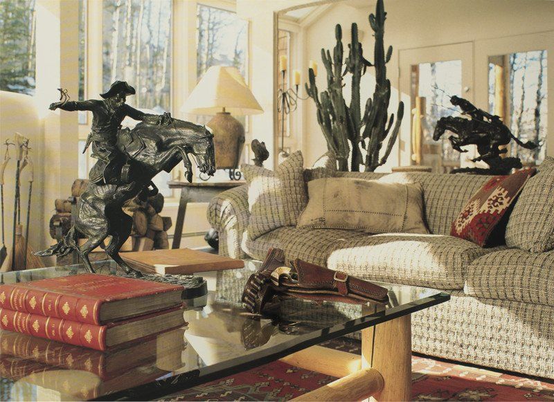 A living room with a statue of a cowboy on a horse