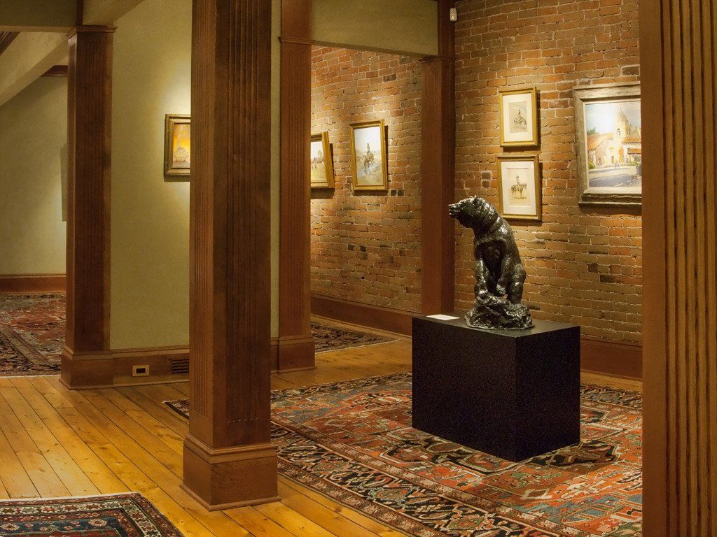 A statue of a bear is on display in a museum