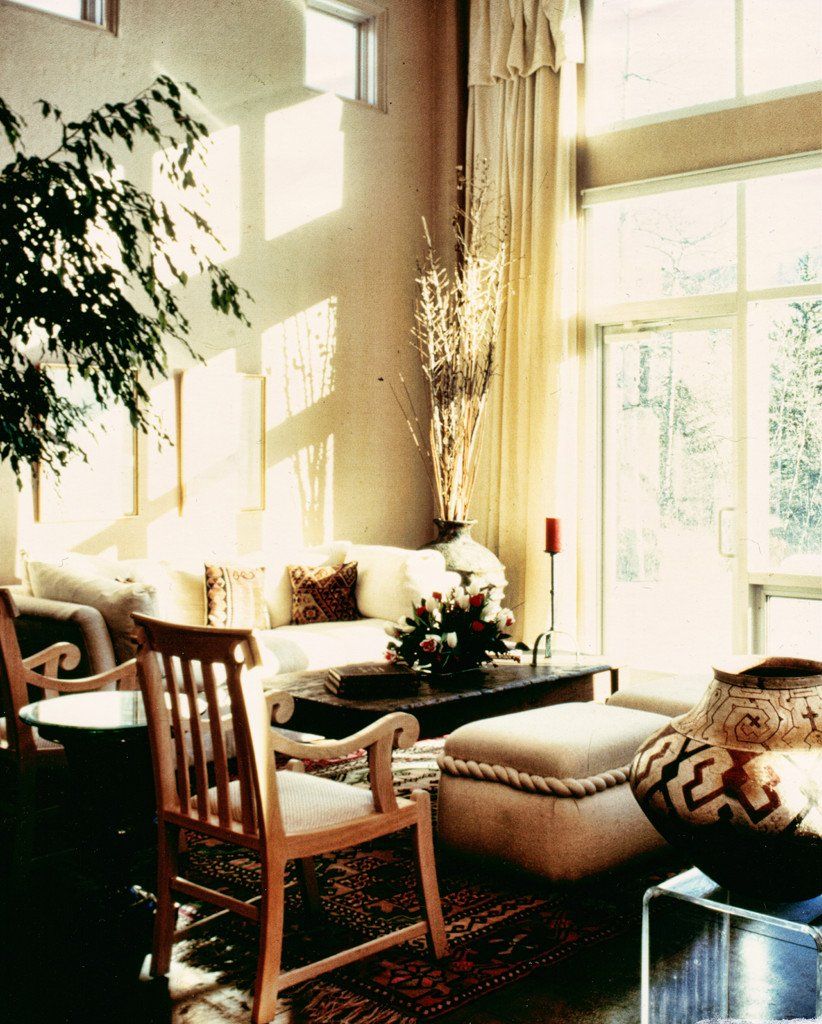 A living room with a couch ottoman and chairs