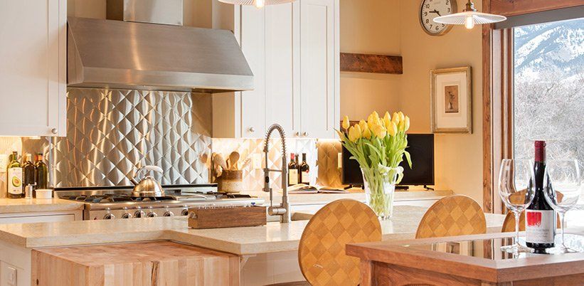 A kitchen with a bottle of wine on the counter
