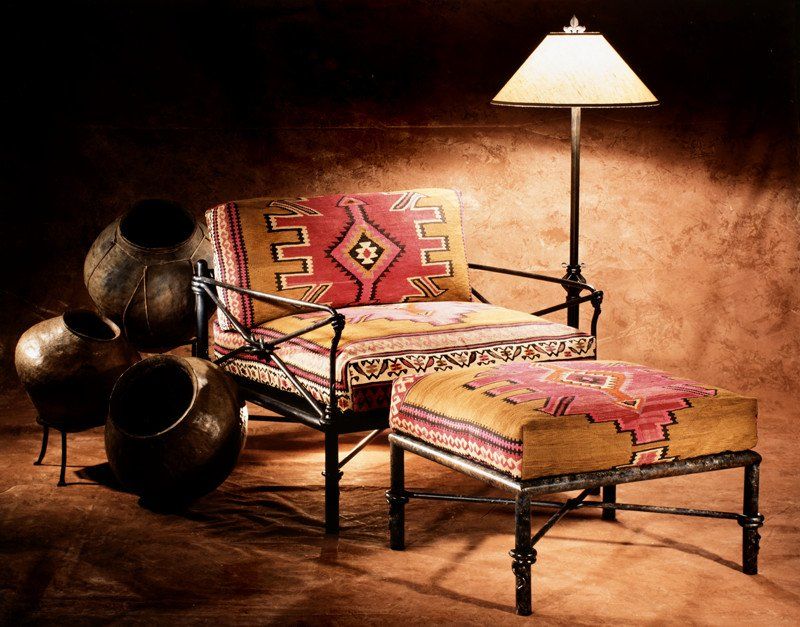 A chair and ottoman with a lamp in the background