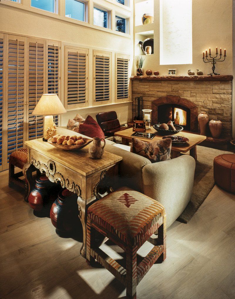 A living room with a couch a table and a fireplace