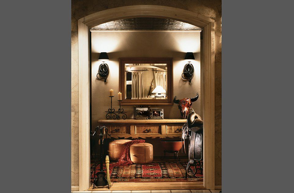 A room with a table and a mirror in it