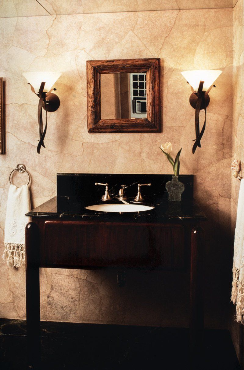 A bathroom with a sink and a mirror on the wall