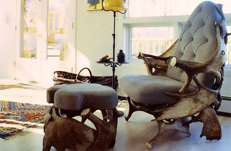 A living room with a chair and ottoman made of antlers