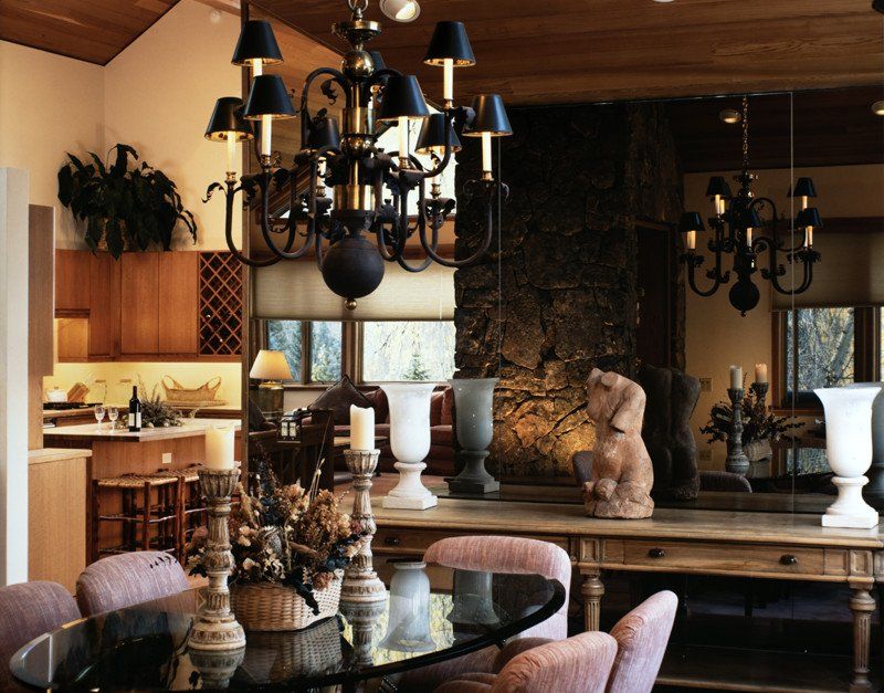 A dining room with a table and chairs and a chandelier